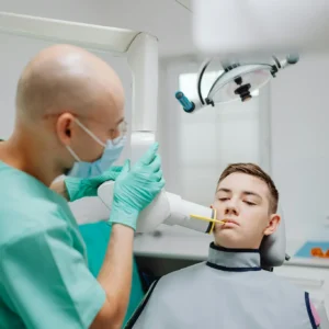 Teen boy receiving dental X-ray in a modern clinic